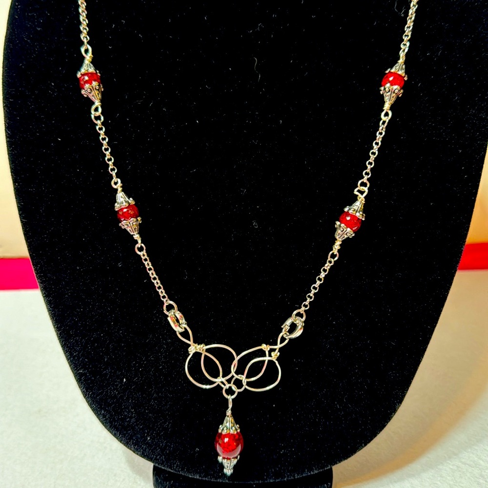 Handmade wire wrapped necklace silver with red beads.